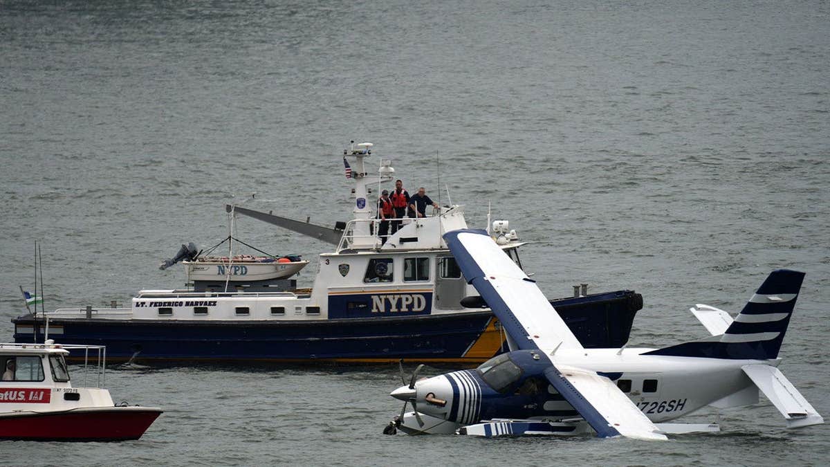 Emergency crews surround a seaplane after it made a hard landing in New York City's East River.