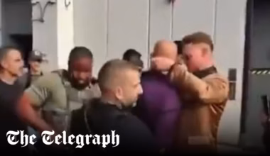 Andrew Tate gives phone away during arrest
