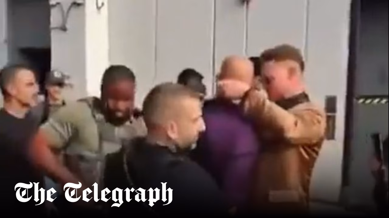 Andrew Tate gives phone away during arrest
