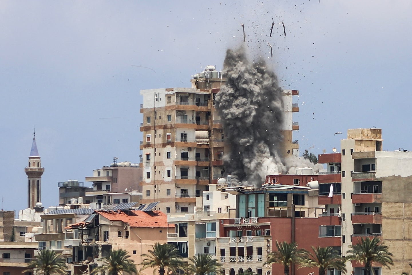 Smoke and debris rose following an Israeli airstrike on Tyre, Lebanon in June.
