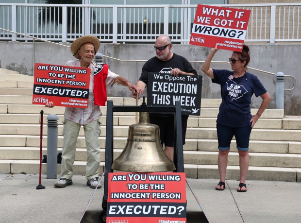 Death penalty protesters Tony Herlich, left, and Abraham Bonowitz toll a bell with SueZann Bosler during a demonstration in front of the Lake County Courthouse in Tavares, Fla., Tuesday, July 28, 2026. Bonowitz, who is executive director of Death Penalty Action, led the protest opposing the scheduled double execution of former Mascotte police officer James Duckett and another Florida death row inmate in Starke on Tuesday. (Joe Burbank/Orlando Sentinel)