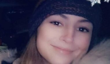 A young woman with long hair, wearing a toque.