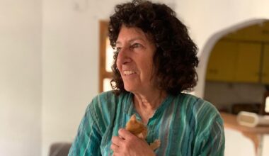 Tova Saul cradles one of the two kittens she most recently rescued in Jerusalem's Old City, May 2026 (Sarah Tuttle-Singer)