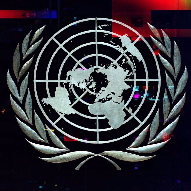 A photo illustration of the United Nations symbol with a glitch effect overlaying it.