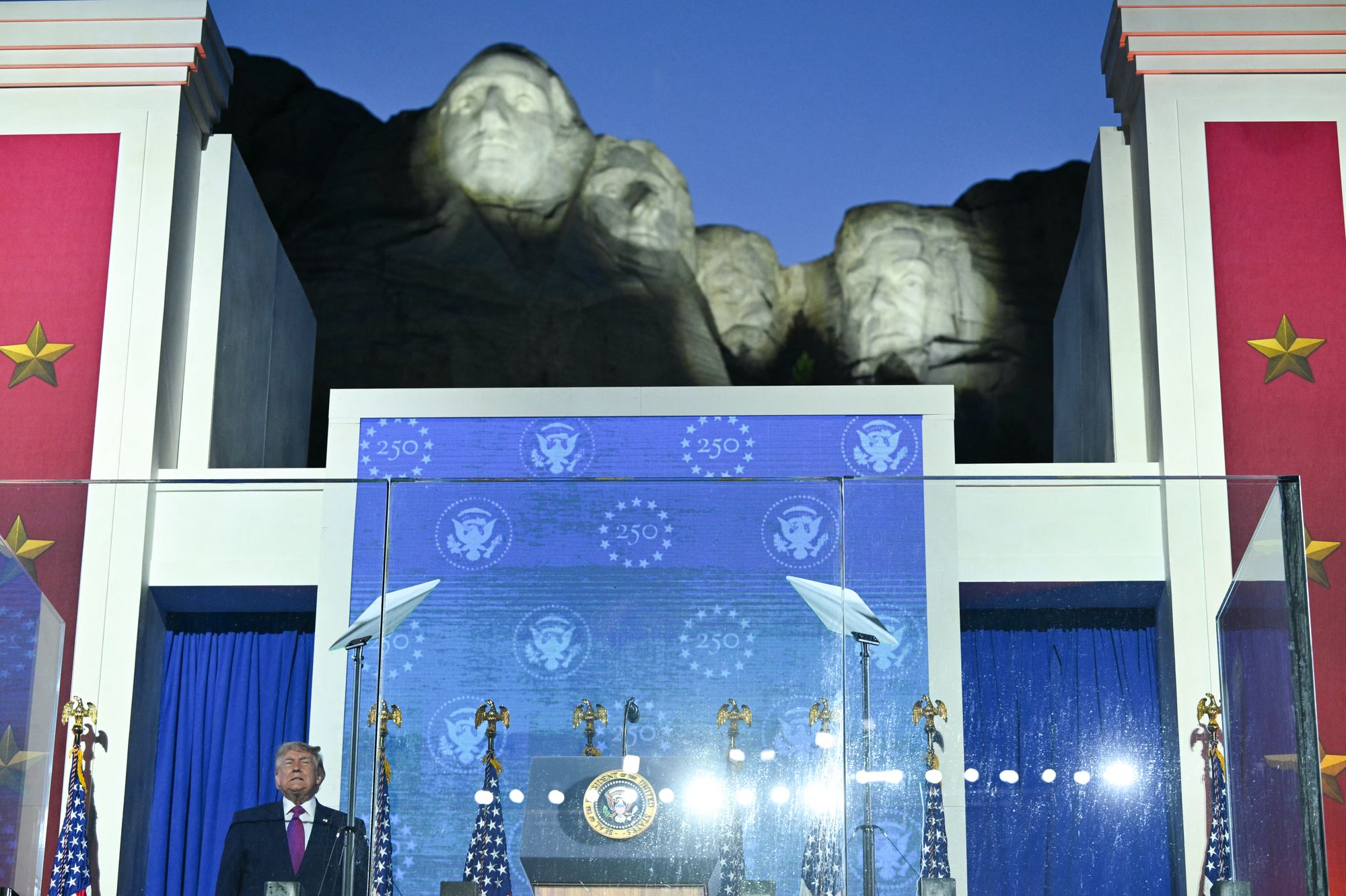 US President Donald Trump steps on stage to deliver remarks during the Independence Day events at Mount Rushmore