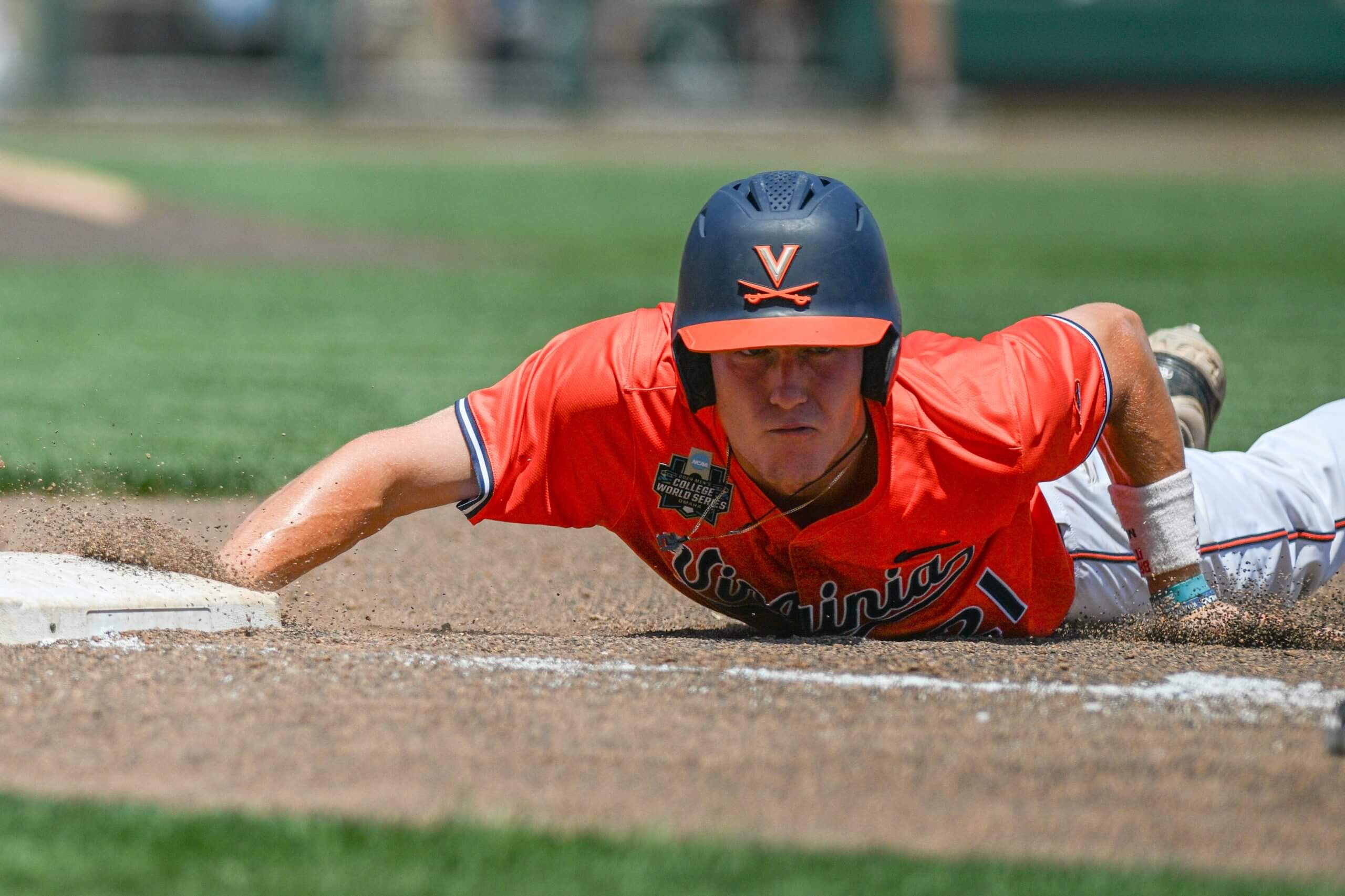 Virginia Cavaliers third baseman Eric Becker (21) slides back into first base against the North Carolina Tar Heels during the fourth inning at Charles Schwab Filed Omaha.