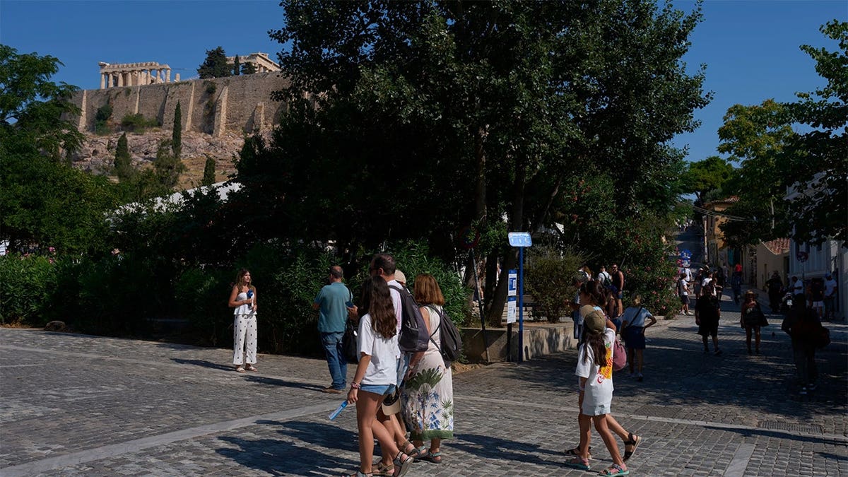 Tourists walking near the Acropolis in Athens, Greece