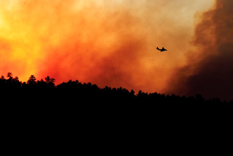 COLORADO CITY, COLORADO - JULY 1: A firefighting plane prepares to drop fire retardant over the Aspen Acres fire on July 1, 2026 in Colorado City, Colorado. Over 35,000 acres and more than 100 structures have burned in the Aspen Acres fire, one of several blazes that are currently burning across the state after a warm and dry winter. Michael Ciaglo/Getty Images/AFP (Photo by Michael Ciaglo / GETTY IMAGES NORTH AMERICA / Getty Images via AFP)