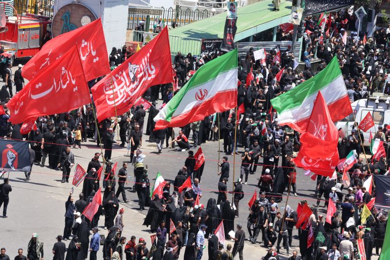 Mourners gather in the street ahead of the funeral of Iran's slain supreme leader Ali Khamenei and members of his family at the Shrine of Imam Reza, Iran's most revered place of worship, in Mashhad on July 9, 2026.