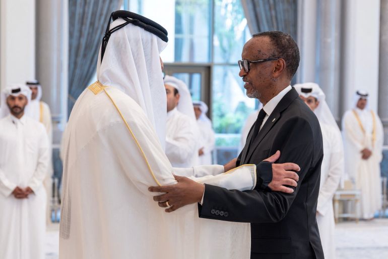 This handout photograph released by Qatar's Amiri Diwan shows Qatar's Emir Sheikh Tamim bin Hamad Al Thani (L) receiving condolences from Rwanda's President Paul Kagame following the death of his father, former leader Sheikh Hamad bin Khalifa Al Thani, at Lusail Palace on the outskirts of Doha on July 13, 2026.