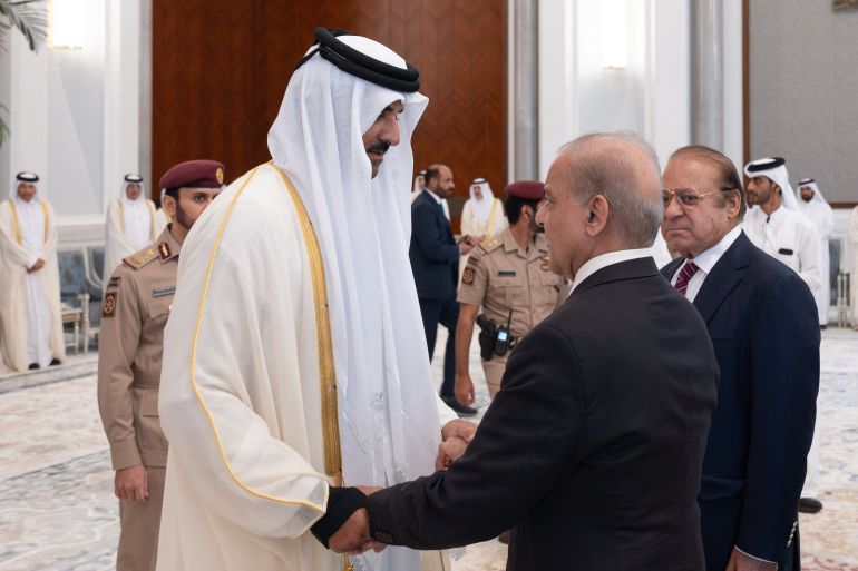 This handout photograph released by Qatar's Amiri Diwan shows Qatar's Emir Sheikh Tamim bin Hamad Al Thani (L) receiving condolences from Pakistan's Prime Minister Shehbaz Sharif following the death of his father, former leader Sheikh Hamad bin Khalifa Al Thani, at Lusail Palace on the outskirts of Doha on July 13, 2026.