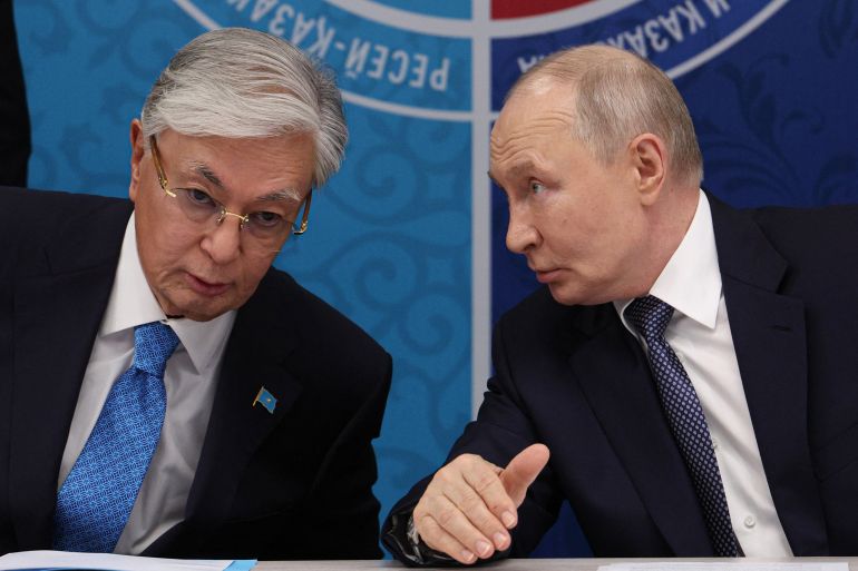 In this pool photograph distributed by the Russian state agency Sputnik, Russia's President Vladimir Putin (R) speaks to Kazakhstan's President Kassym-Jomart Tokayev as they attend the 22nd Russia-Kazakhstan Forum of Interregional Cooperation in Omsk on July 25, 2026.