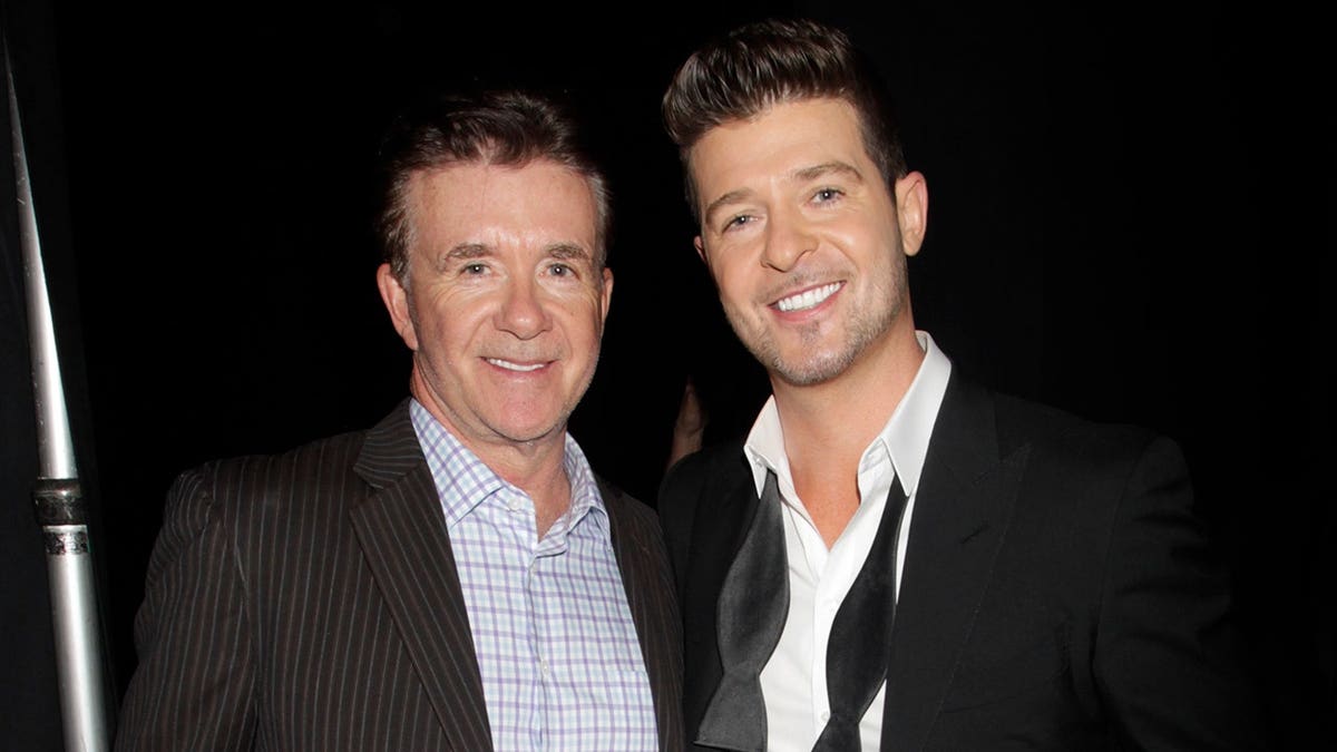 Alan Thicke stands with Robin Thicke backstage.
