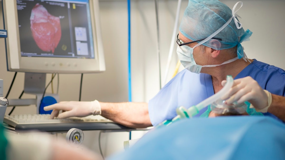 Anesthetist helping patient