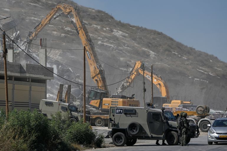 Israeli army bulldozers demolish a Palestinian building in the West Bank village of Anza, Monday, July 27, 2026. [File: Majdi Mohammed/AP]