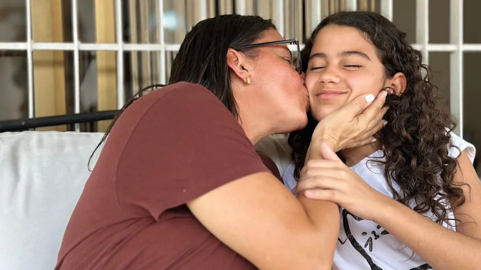 Karina (left) kisses her daughter Fabiana.