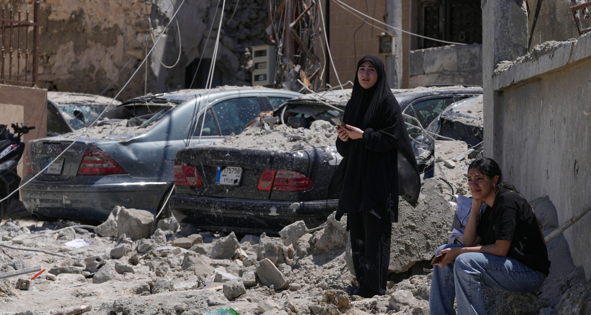 Relatives of missing victims weep, as they gather at the site of destroyed buildings that were hit in an Israeli airstrike in Qannarit village, southern Lebanon, Saturday, June 20, 2026. (AP Photo/Mohammed Zaatari)