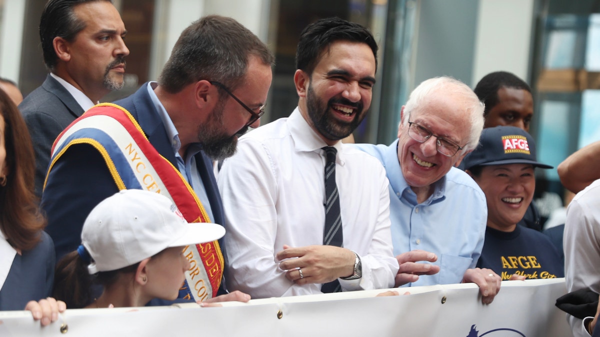Bernie Sanders and Zohran Mamdani marching