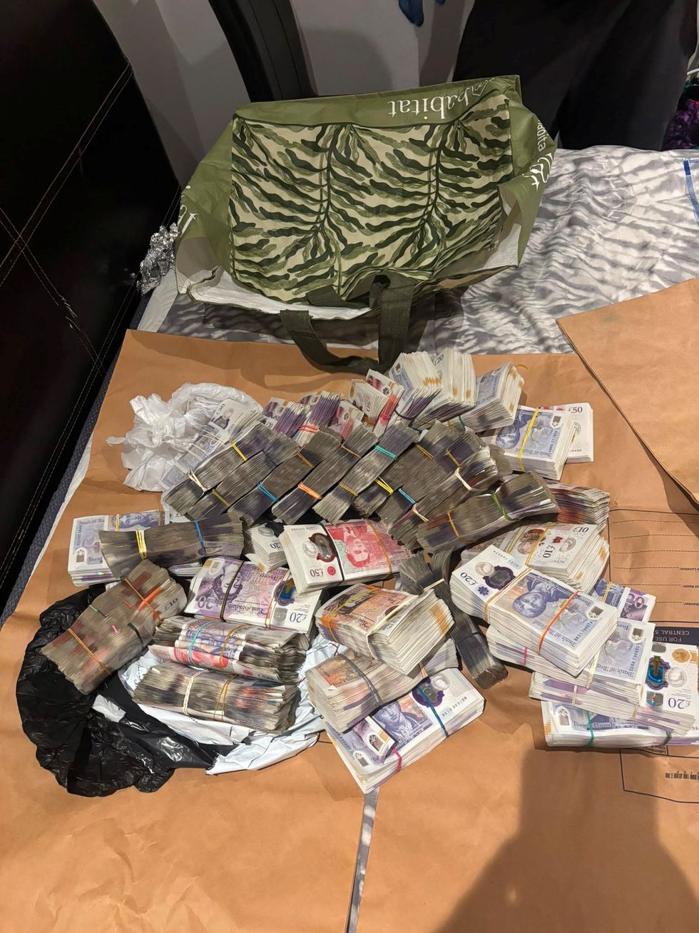 Bundles of cash on evidence bags in South London home