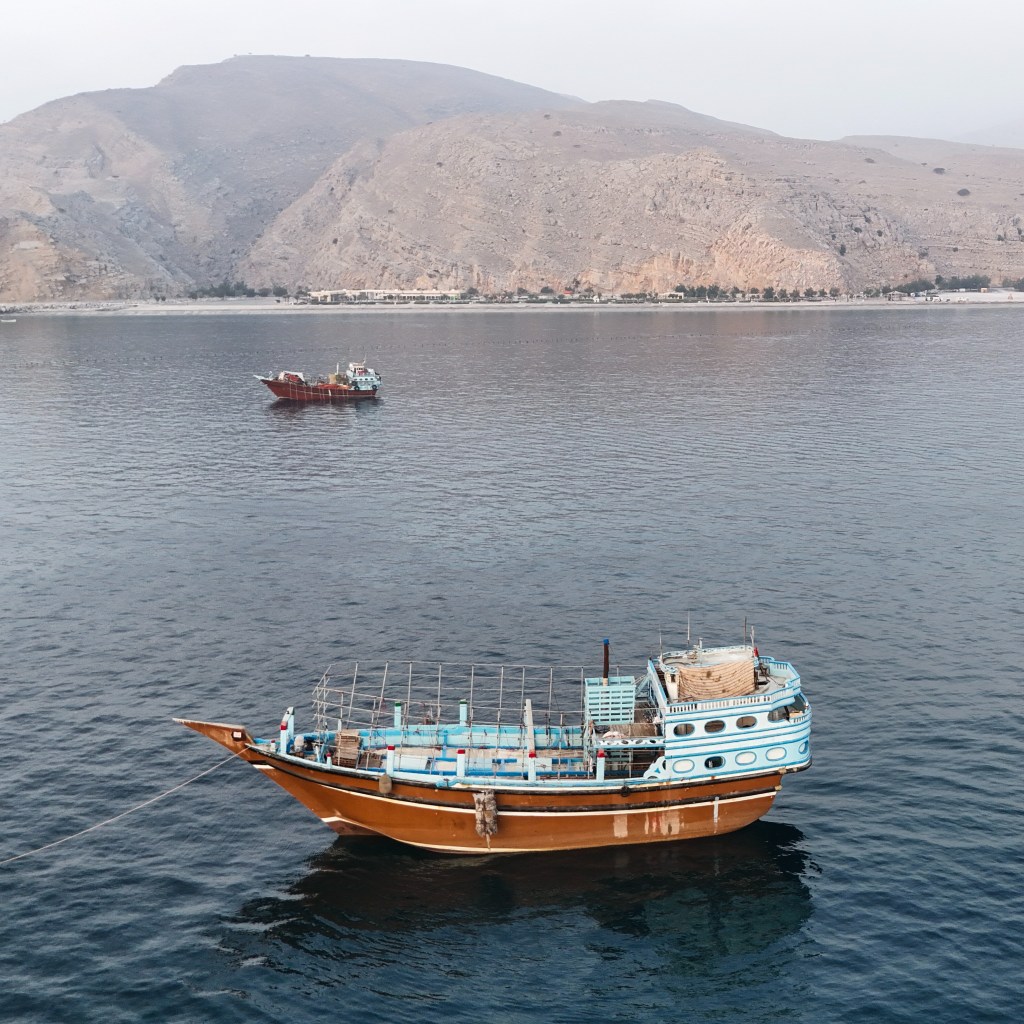 Aerial view of two boats anchored in the water off Oman's Musandam Peninsula near the Strait of Hormuz.