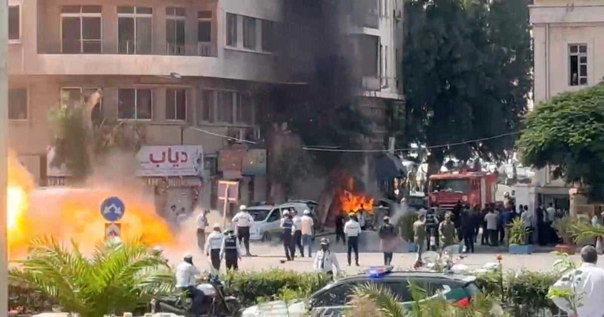 Explosive devices blow up near a hotel where French President Emmanuel Macron was meant to be staying, in Damascus