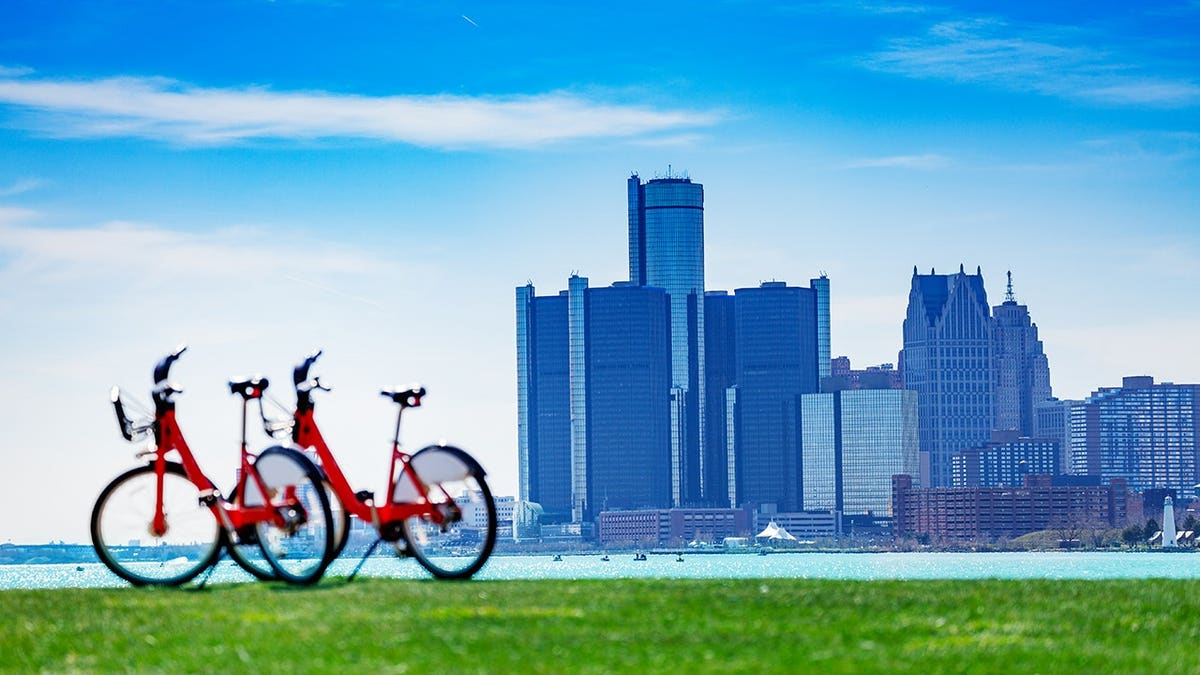 City bicycles stand on Sunset Point overlooking the Detroit River and downtown Detroit.