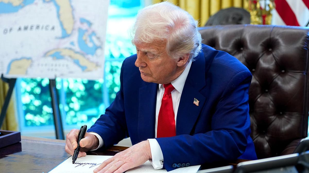 Trump signs executive order in Oval Office on U.S. shipbuilding.