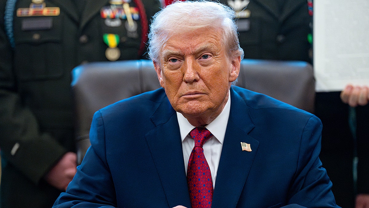 President Donald Trump in front of military members.