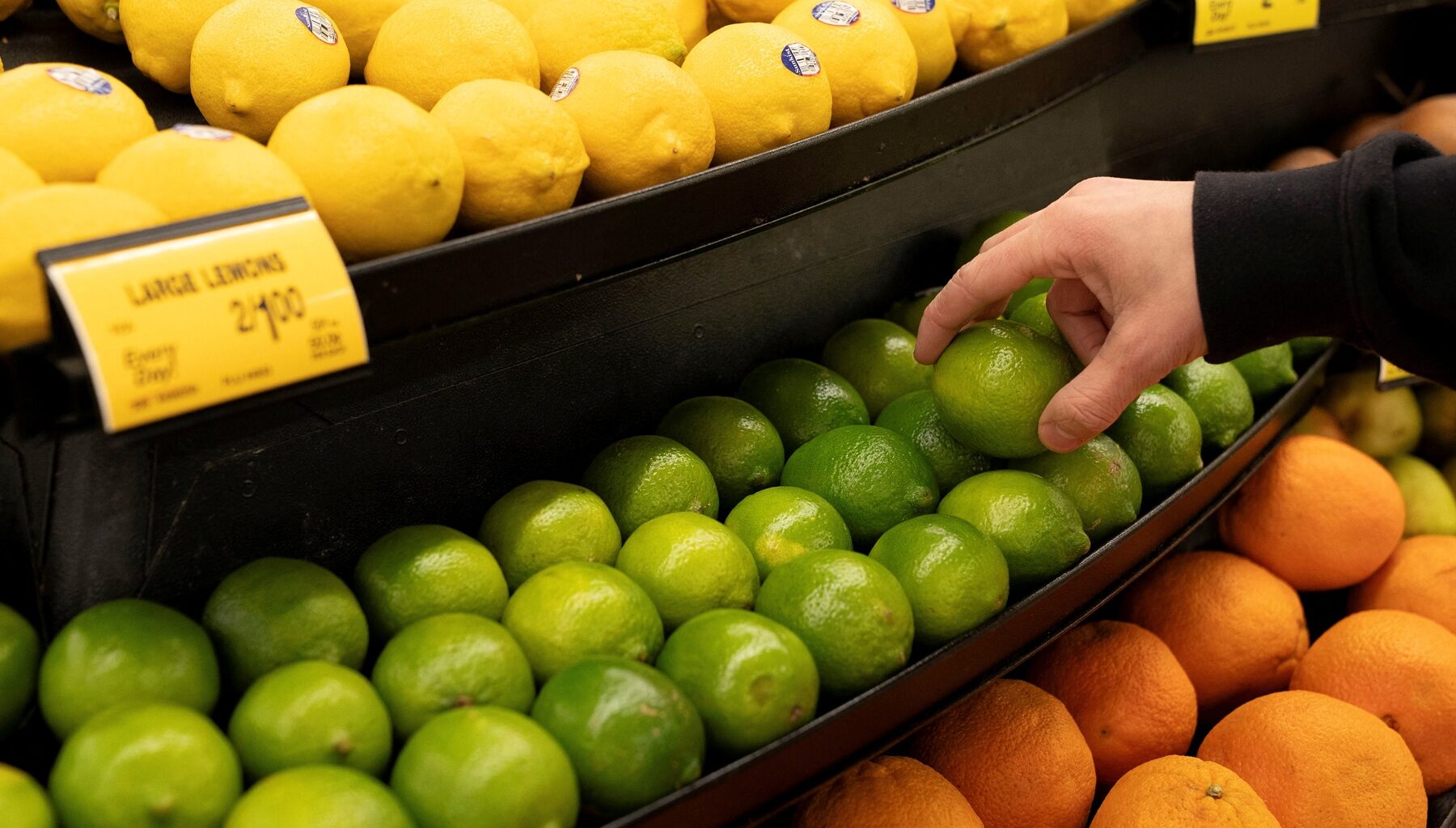 A worker stocks limes ahead of the Thanksgiving Day holiday at an Albertsons supermarket in Redmond, Washington, on Nov. 24, 2025. (REUTERS/David Ryder)