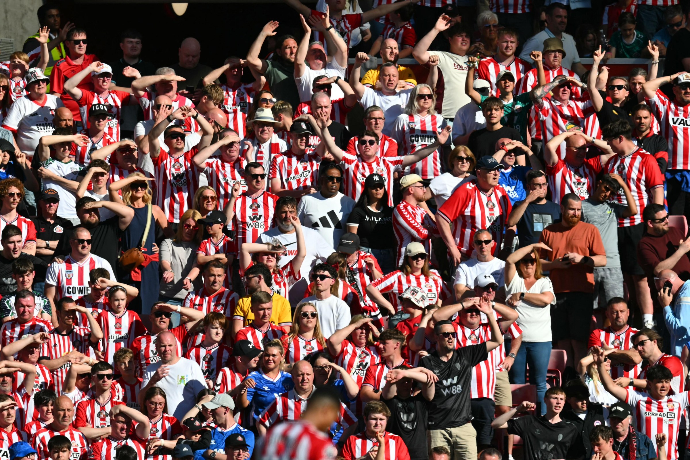 Sunderland fans watch in the sunshine during the English Premier League football match between Sunderland and Chelsea at The Stadium of Light in Sunderland in north east England on May 24, 2026. (Photo by ANDY BUCHANAN / AFP via Getty Images) / RESTRICTED TO EDITORIAL USE. No use with unauthorized audio, video, data, fixture lists, club/league logos or ‘live’ services. Online in-match use limited to 120 images. An additional 40 images may be used in extra time. No video emulation. Social media in-match use limited to 120 images. An additional 40 images may be used in extra time. No use in betting publications, games or single club/league/player publications. /