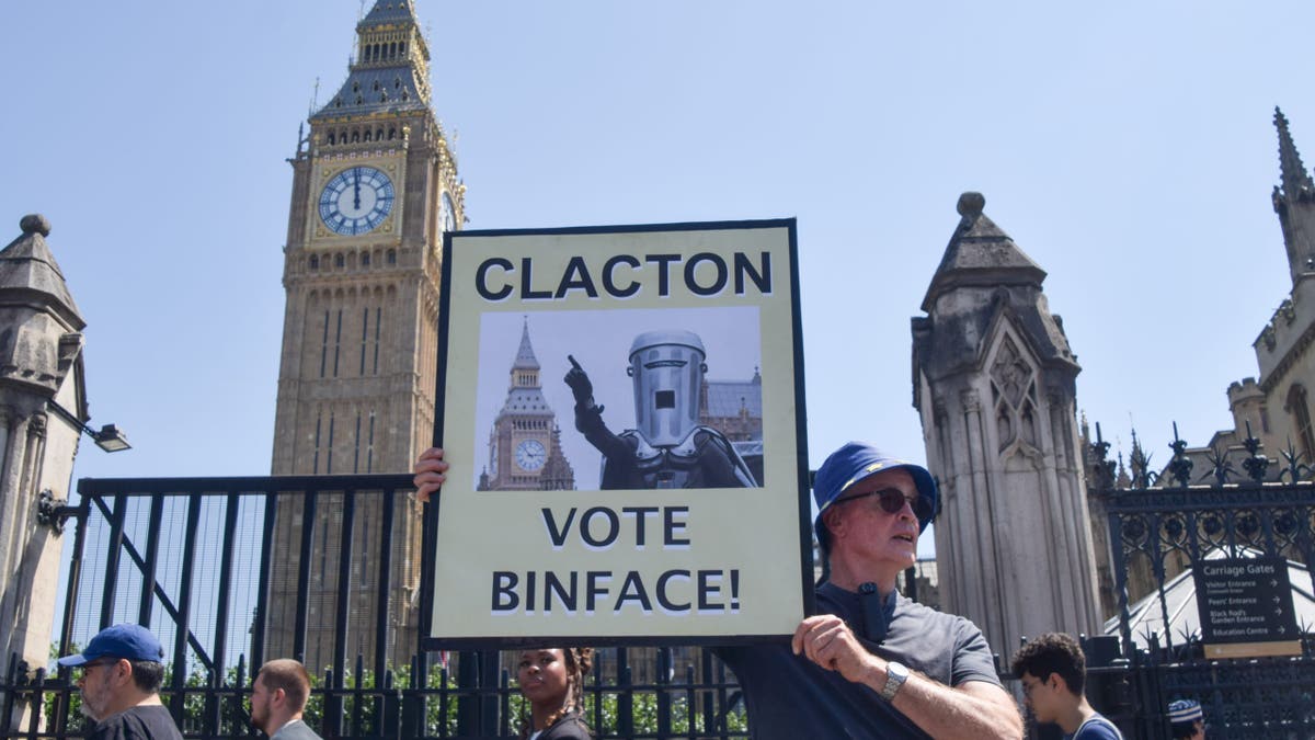 An activist holds a placard urging Clacton to vote for Count Binface