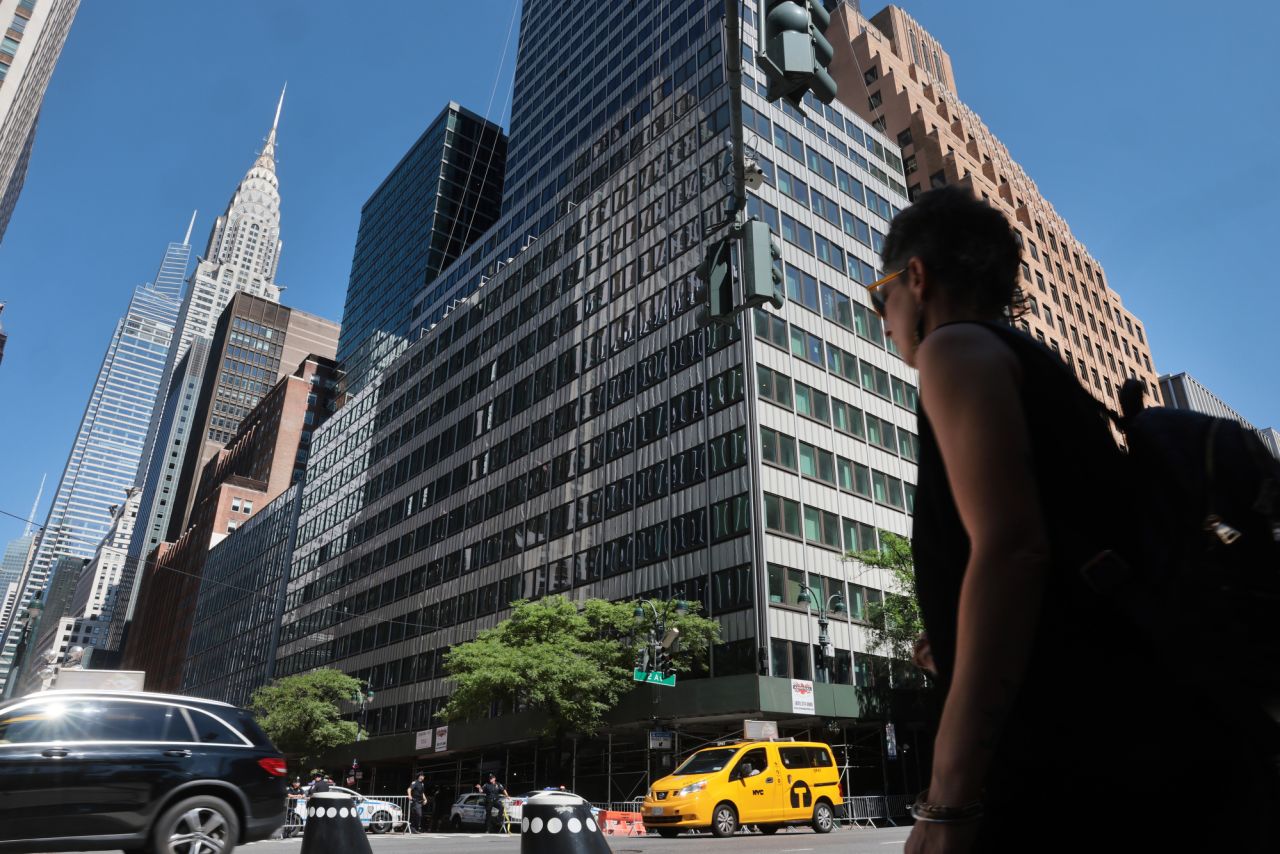 People move past the former Pfizer headquarters building on Wednesday.