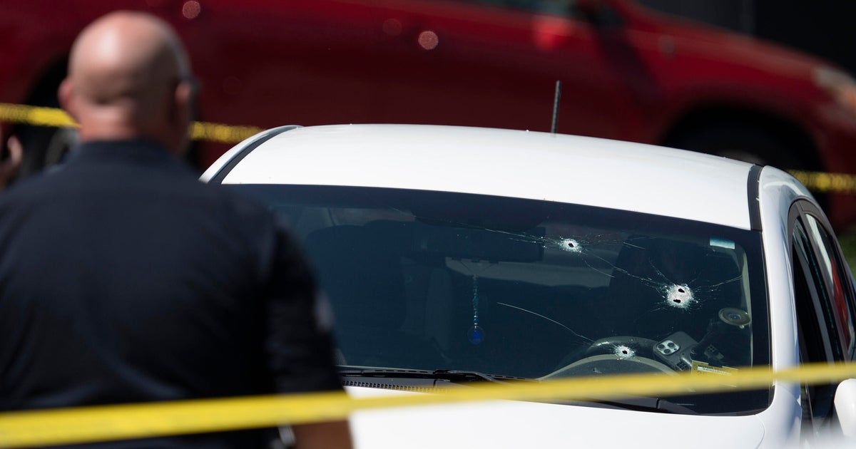 A Kia sedan with four bullet holes in the windshield is seen at the scene of a shooting in Biddeford, Maine, July 13, 2026.