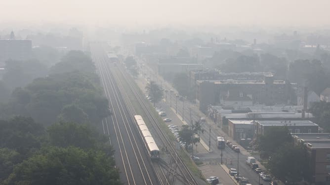 A CTA âLâ Green Line train runs through haze from Canadian wildfires on the West Side of Chicago, July 16, 2026, in the Austin neighborhood.