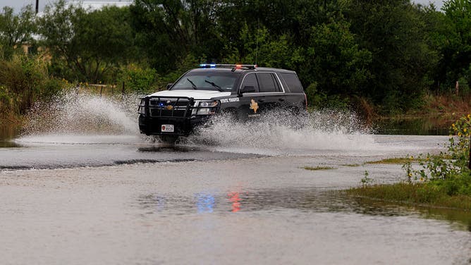 UVALDE AND CONCAN, TEXAS - JULY 15: A Texas Department of Public Safety vehicle drives through standing water in Uvalde on Wednesday, July 15, 2026.