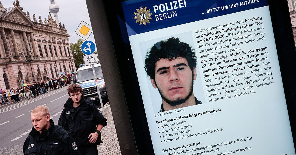 A public information screen displays a Berlin police appeal