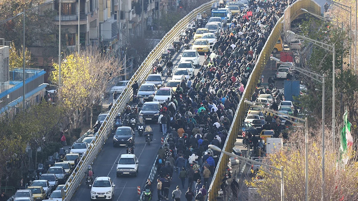 Iran hangs 2 protesters in public, crowd cries 'dishonorable' as security fires tear gas