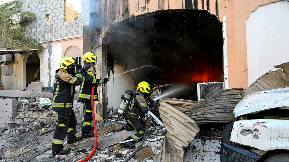 Firefighters work in the aftermath of Iranian drone attacks in Bahrain