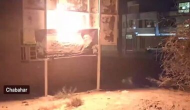 A state propaganda banner is set ablaze by underground opposition networks in Chabahar during a nighttime operation in June 2026
