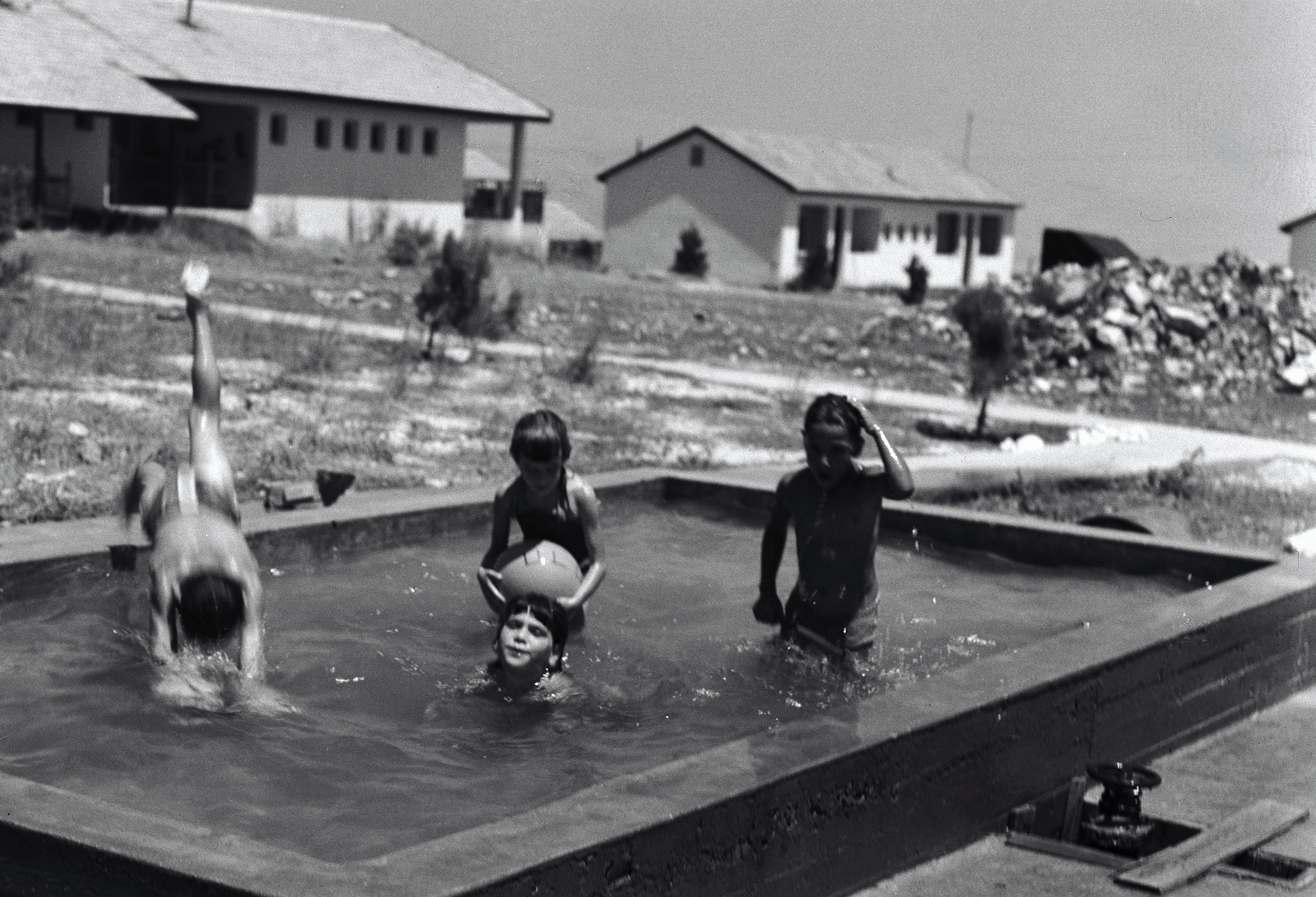 Israeli children enjoy a makeshift swimming pool, 1940. Photo by Avraham Malevsky, KKL-JNF Photo Archive.