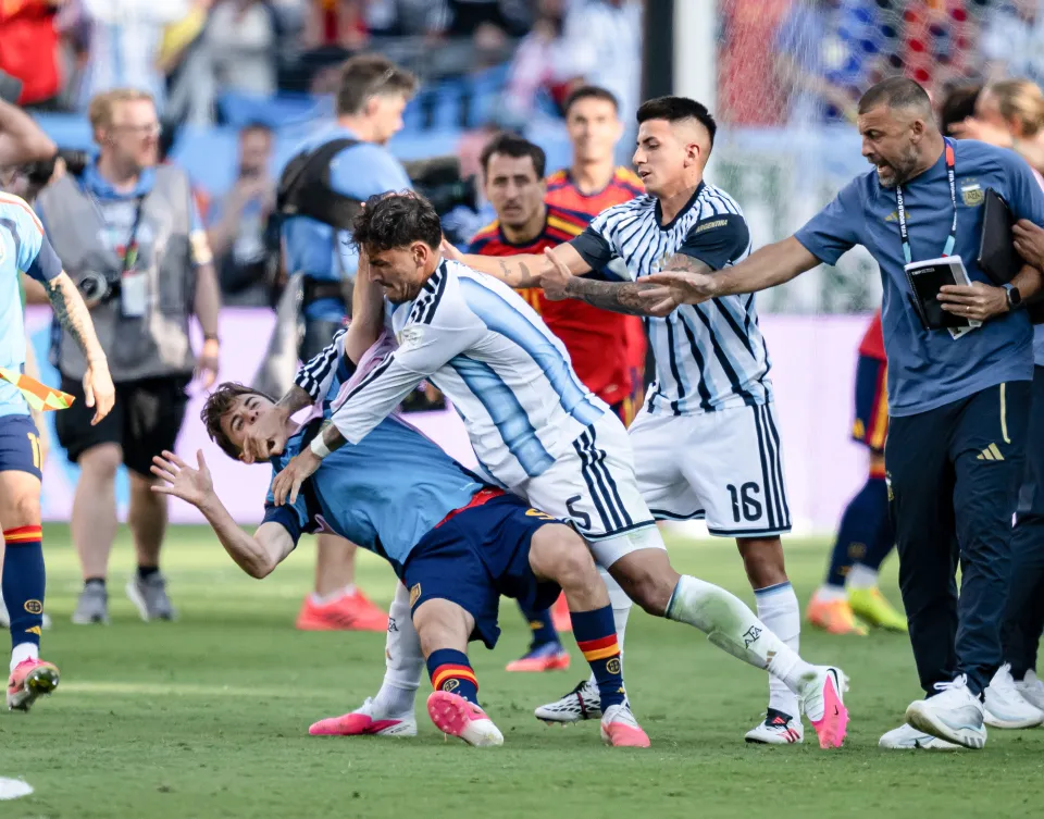 Argentina player Leandro Parades pushes Spain player Gavi - wearing a light blue substitute's bib - to the ground amid altercations on the pitch following the 2026 World Cup final.