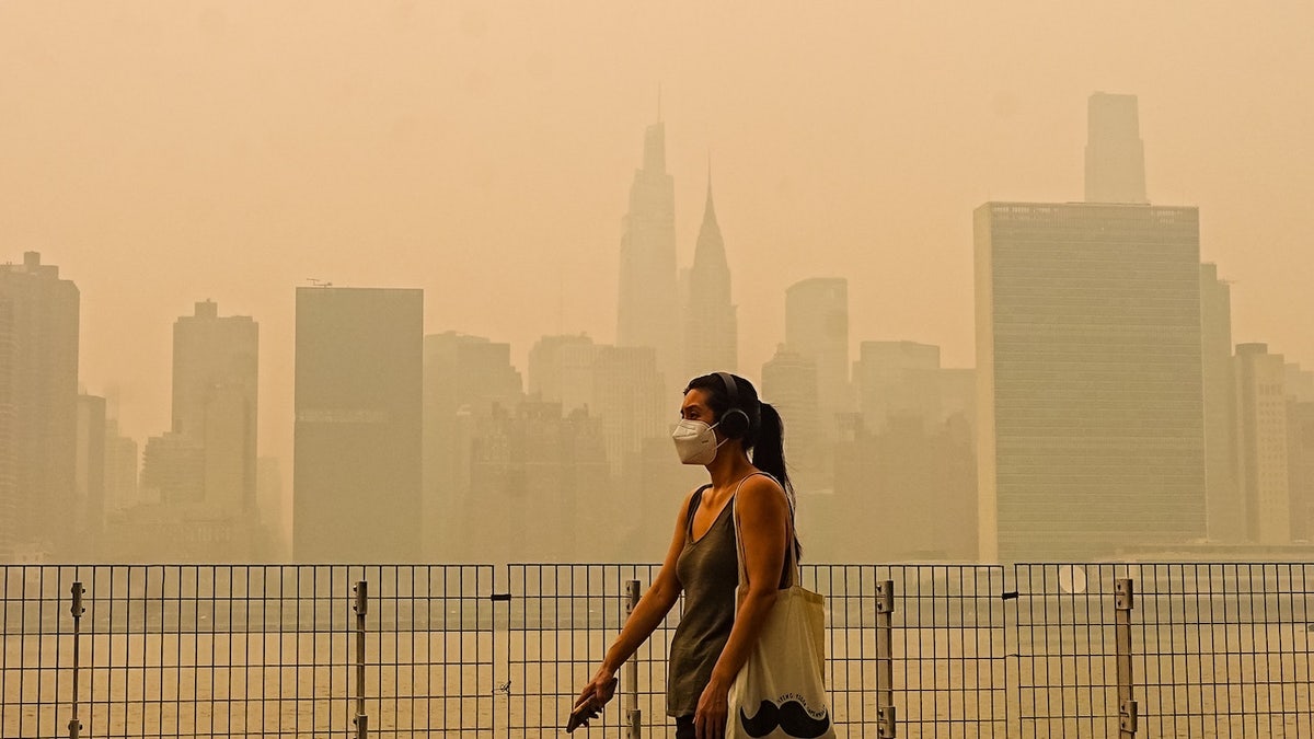 Woman in mask in NYC amid wildfire smoke