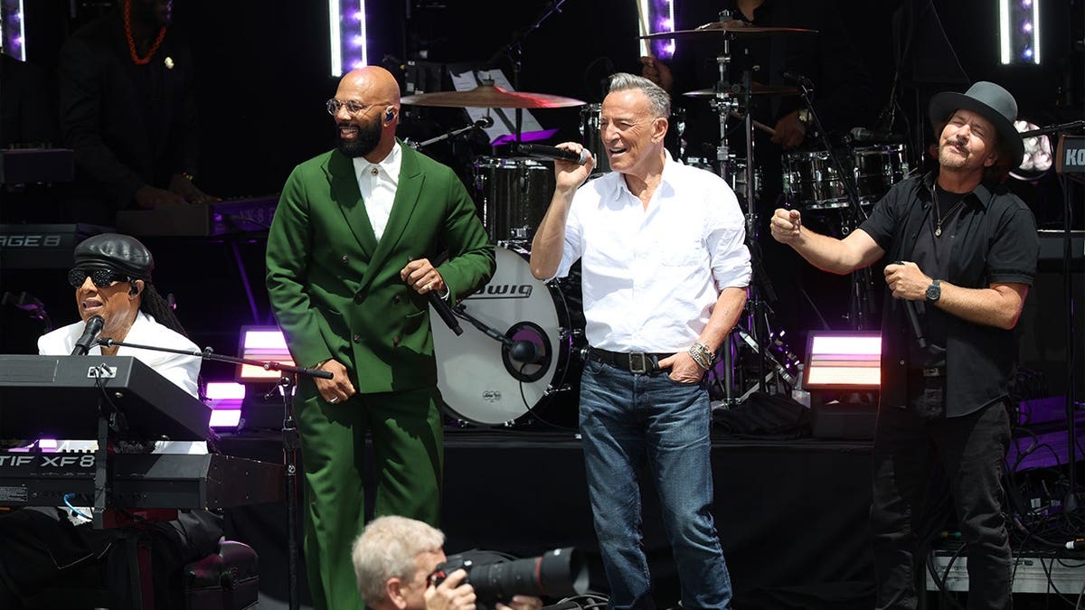 Stevie Wonder, Common, Bruce Springsteen and Eddie Vedder perform together onstage during the Obama Presidential Center dedication ceremony.