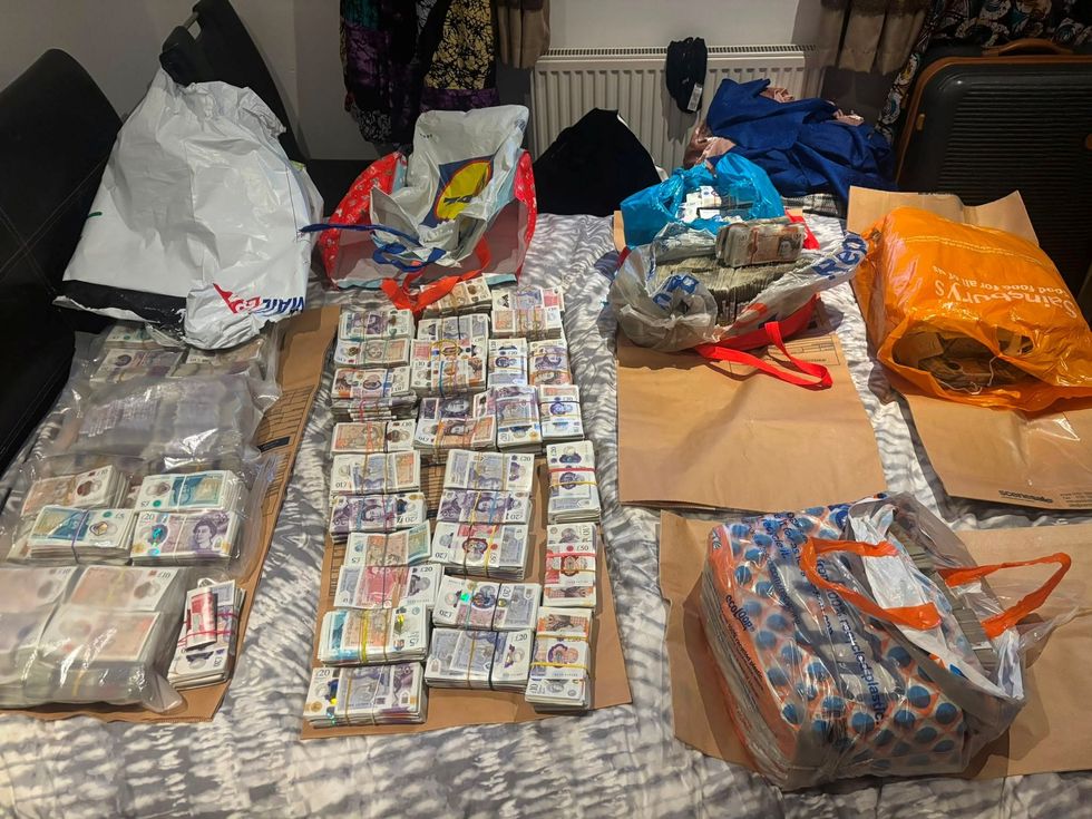 Piles of cash spread out neatly, found in a South London home