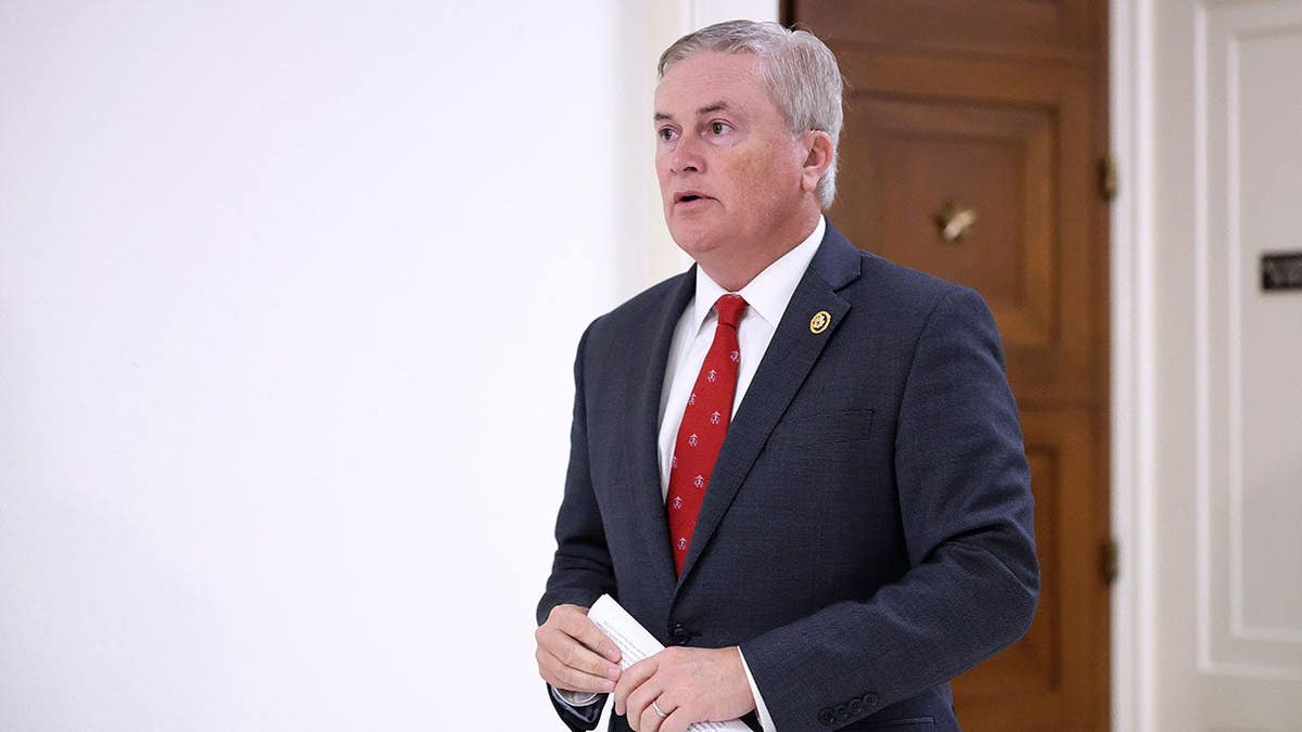 Rep. James Comer walking in a hallway before a closed-door interview
