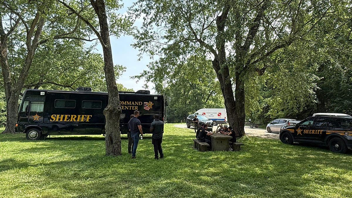 Officials stand at a staging area near the Scioto River in Powell, Ohio.