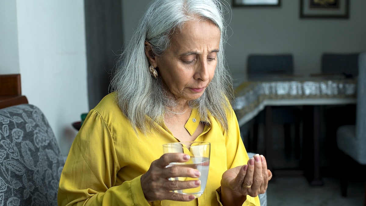 Senior woman taking medication