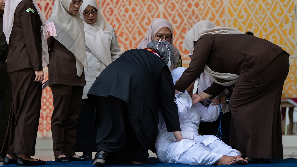woman falls near group of other women