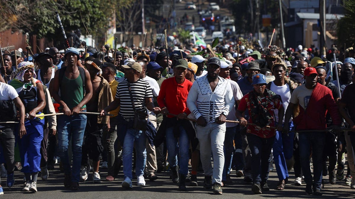 crowds of marchers walk through street
