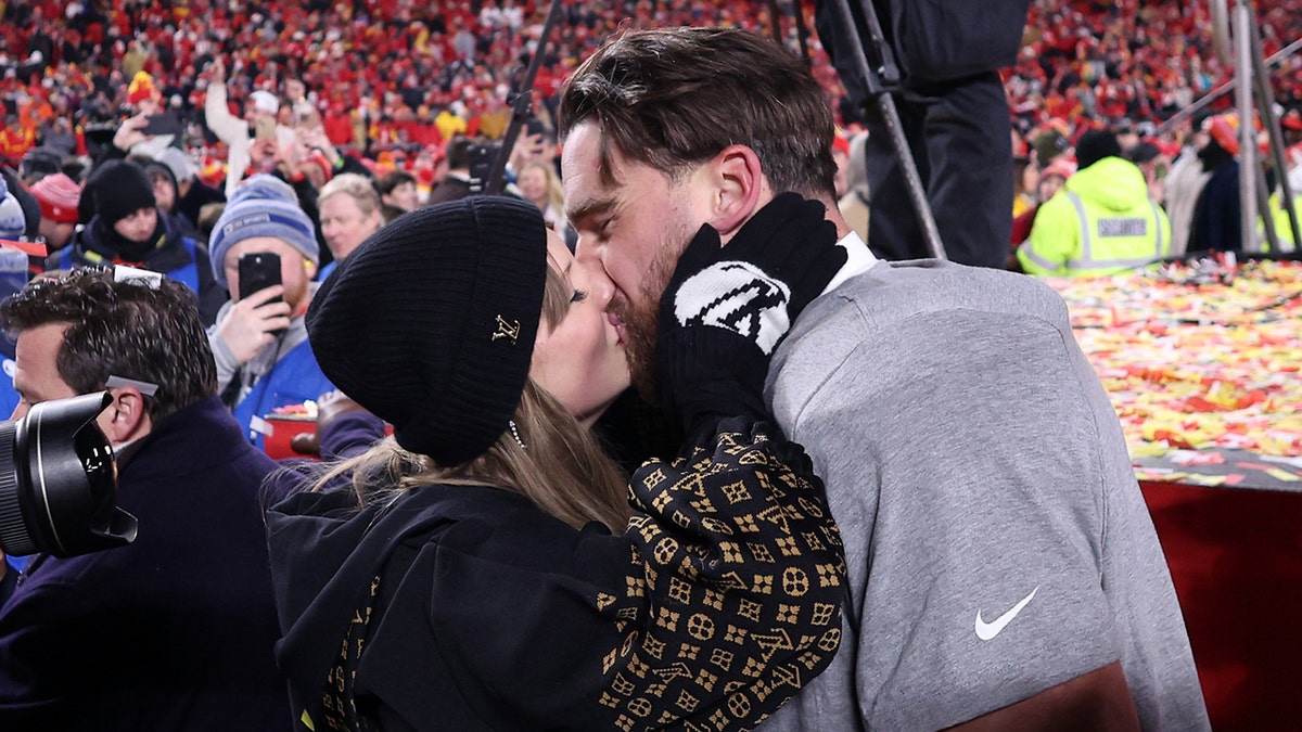 Taylor Swift and Travis Kelce kiss on the football field